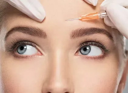 Woman receiving a Botox injection in the forehead