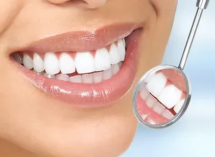Bright, healthy smile reflected in a dental mirror after a teeth cleaning